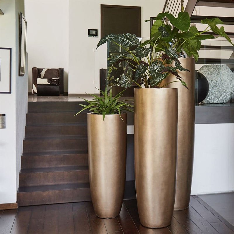 Silver sculptural face fiberglass vases on black pedestal bases