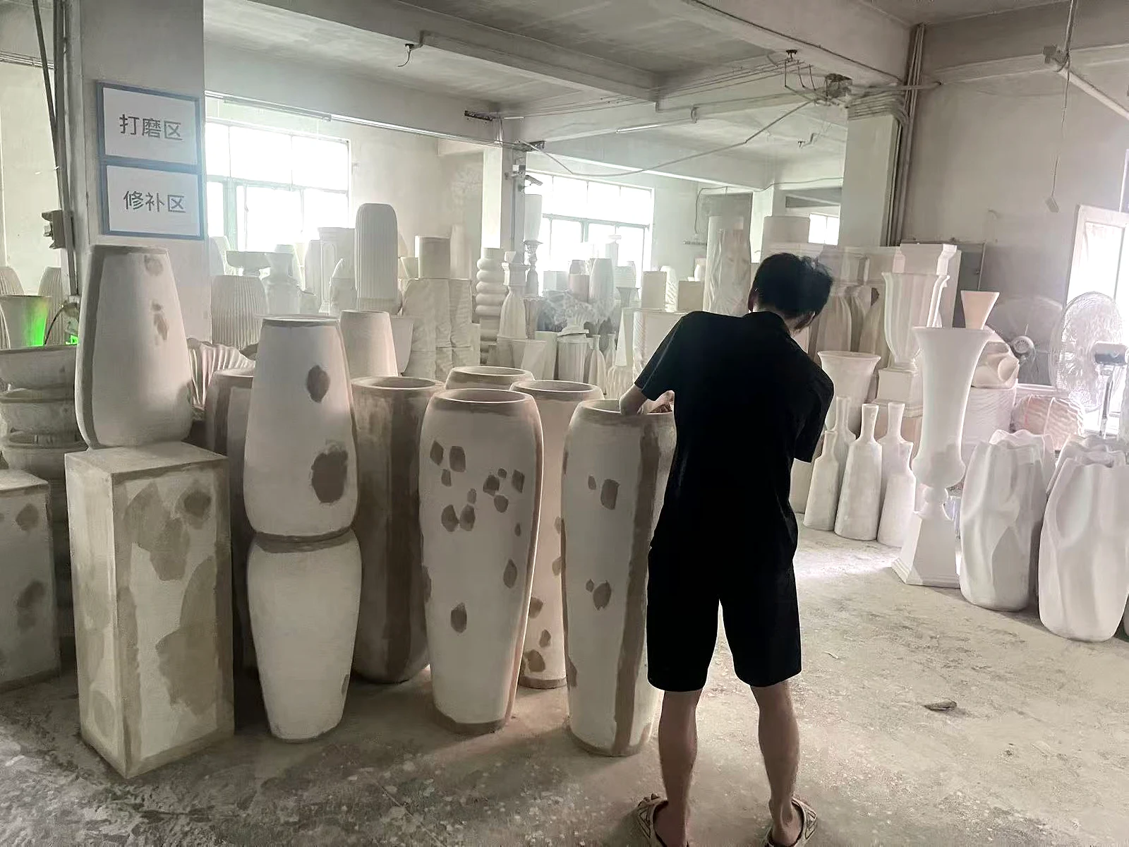 Craftsman sanding and repairing magnesium oxide planters